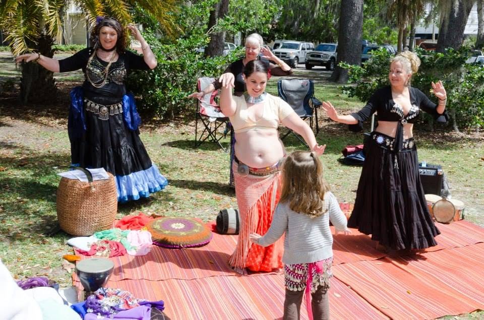 Jessica Shirvan belly dancing with a young student at a festival