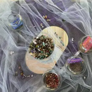 Fairy Spell Pouch workshop ingredients — tumbled stones, dried rose petals, lavender, and starry organza pouches